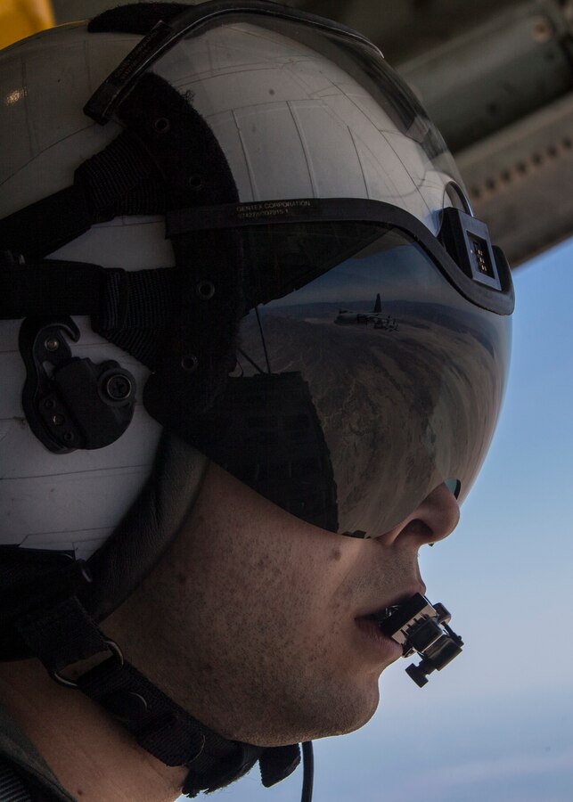 Cpl. John Elie, a crew master for Marine Aerial Refueler Transport Squadron (VMGR) 352, Marine Aircraft Group 11, 3rd Marine Aircraft Wing, observes a KC-130J Super Hercules ceremonial formation flight for the VMGR-352 75th anniversary at Marine Corps Air Station Miramar, Calif., March 30. The squadron held a battle color ceremony, which consisted of a reading of the unit’s citations and awards, a color guard, a performance by the 3rd MAW band and a ceremonial formation flight. (U.S. Marine Corps photo by Lance Cpl. Clare J. McIntire/released)