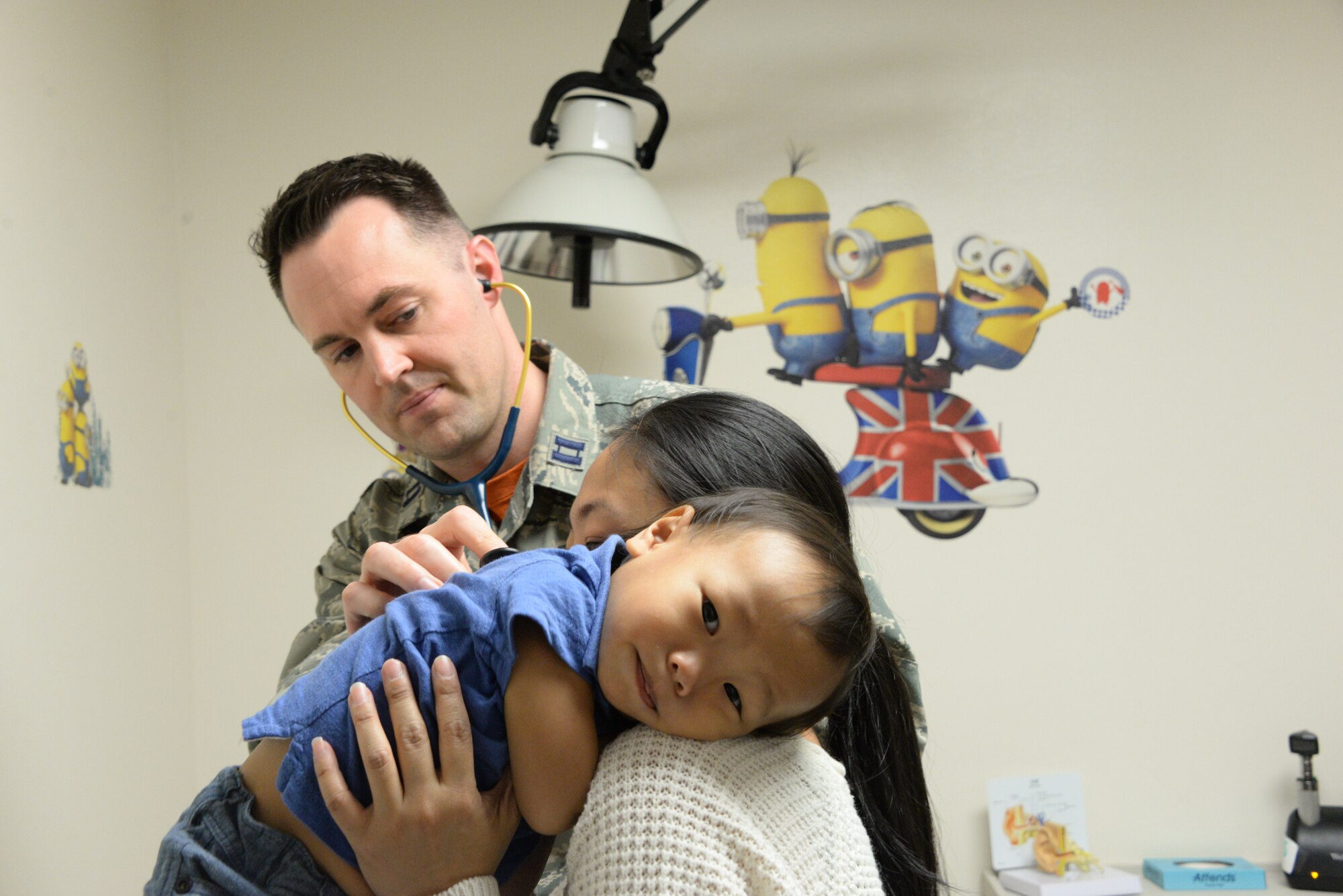 Levi, center, is held by his mother, Jolene Abaya, during a check-up March 30, 2018, with Capt. (Dr.) Steven Williams, 60th Medical Operations Squadron staff pediatrician, at the David Grant USAF Medical Center Pediatric Clinic at Travis Air Force Base, Calif. The Pediatric Clinic cares for 4,500 military children between the ages of newborn to 18 years old. (U.S. Air Force photo by Staff Sgt. Amber Carter).