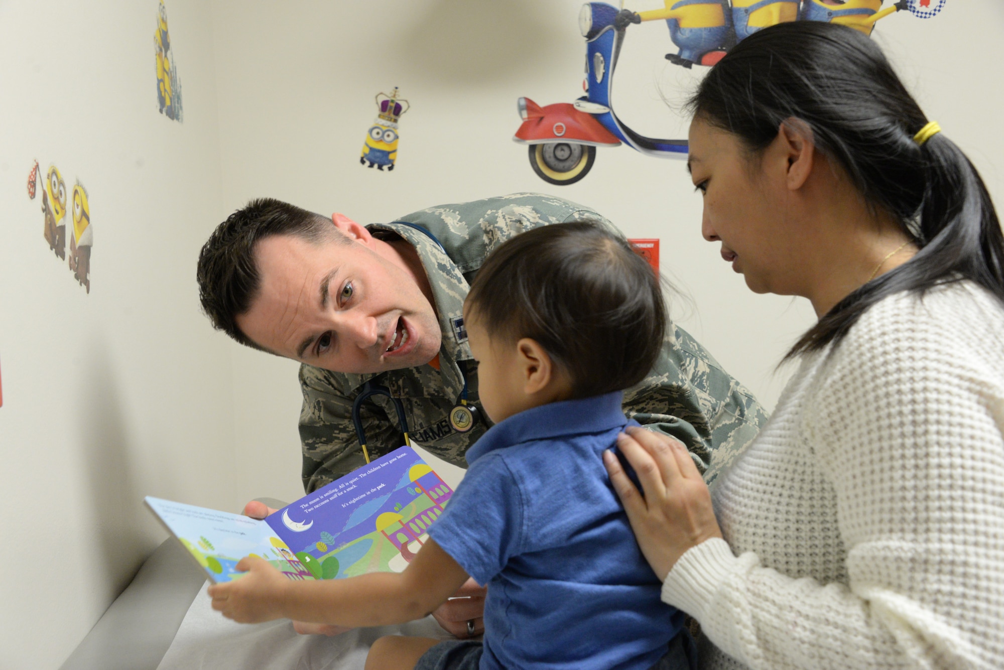 Levi, center, is held by his mother, Jolene Abaya, during a check-up March 30, 2018, with Capt. (Dr.) Steven Williams, 60th Medical Operations Squadron staff pediatrician, at the David Grant USAF Medical Center Pediatric Clinic at Travis Air Force Base, Calif. The Pediatric Clinic cares for 4,500 military children between the ages of newborn to 18 years old. (U.S. Air Force photo by Staff Sgt. Amber Carter).