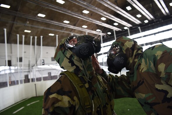 Airmen check one another’s seal during chemical, biological, radiological, nuclear and environmental training at Ellsworth Air Force Base, S.D., March 23, 2018. Emergency management Airmen from the 28th Civil Engineer Squadron work with the 28th Logistics Readiness Squadron and 28th Medical Operations Squadron bioenvironmental engineering flight to keep Ellsworth AFB Airmen proficient with their mission oriented protective posture gear. (U.S. Air Force photo by Airman 1st Class Donald C. Knechtel)