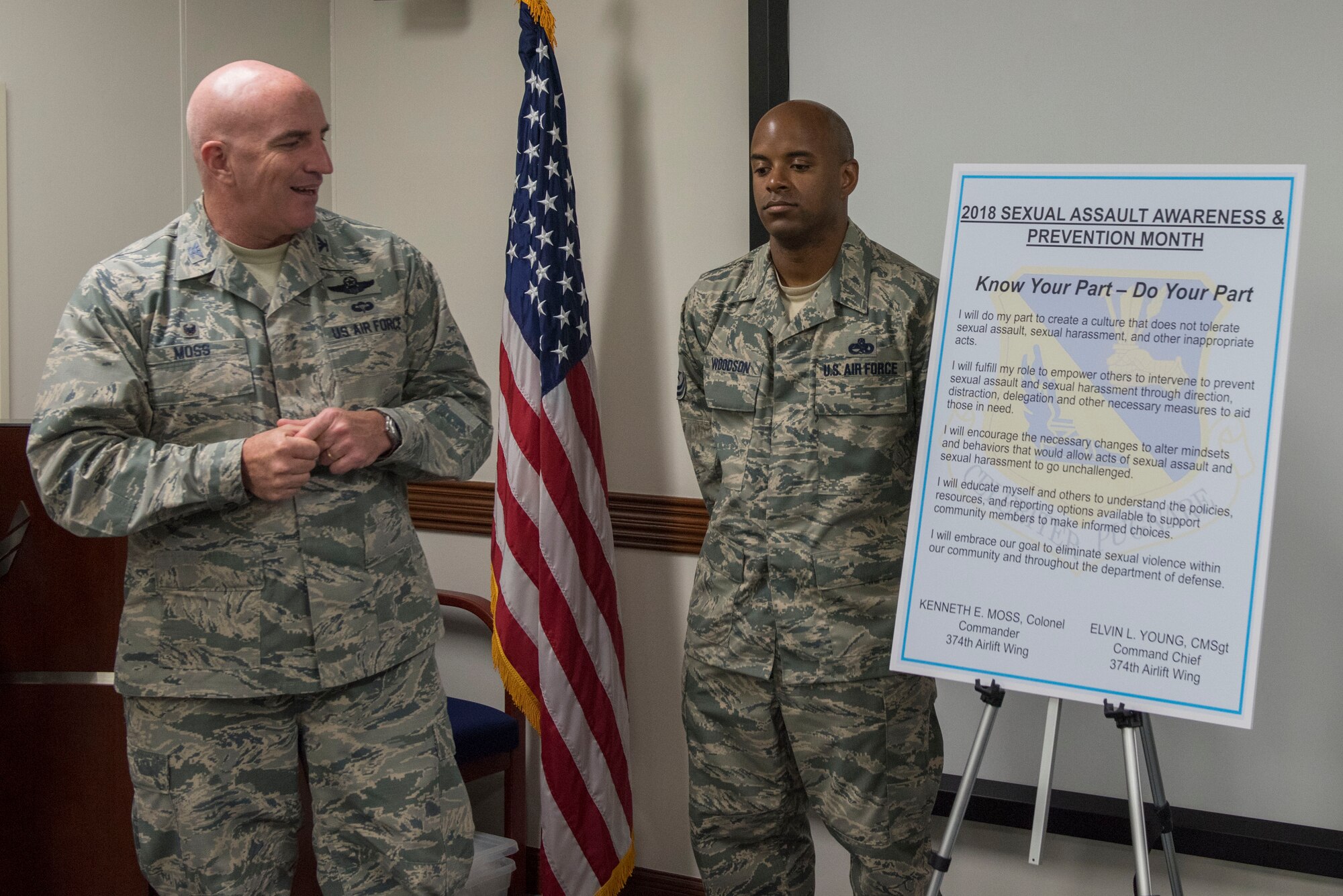 Col. Kenneth E.  Moss, 374th Airlift Wing commander, takes a moment to read over the Sexual Assault Awareness & Prevention Month proclamation at Yokota Air base Japan, April 3, 2018.