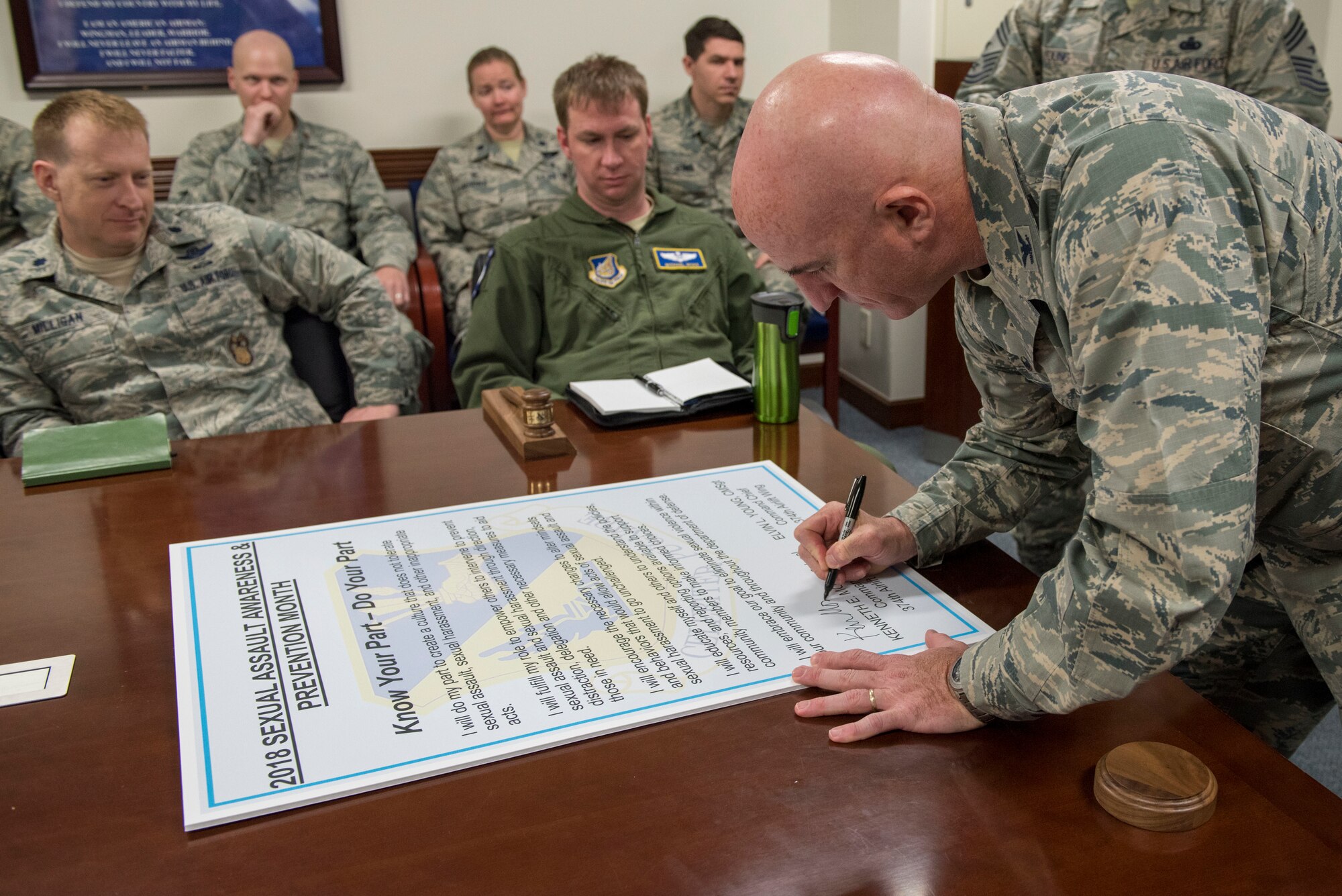 Col. Kenneth E. Moss, 374th Airlift Wing commander, signs the Sexual Assault Awareness & Prevention Month proclamation at Yokota Air Base, Japan, April 3, 2018.