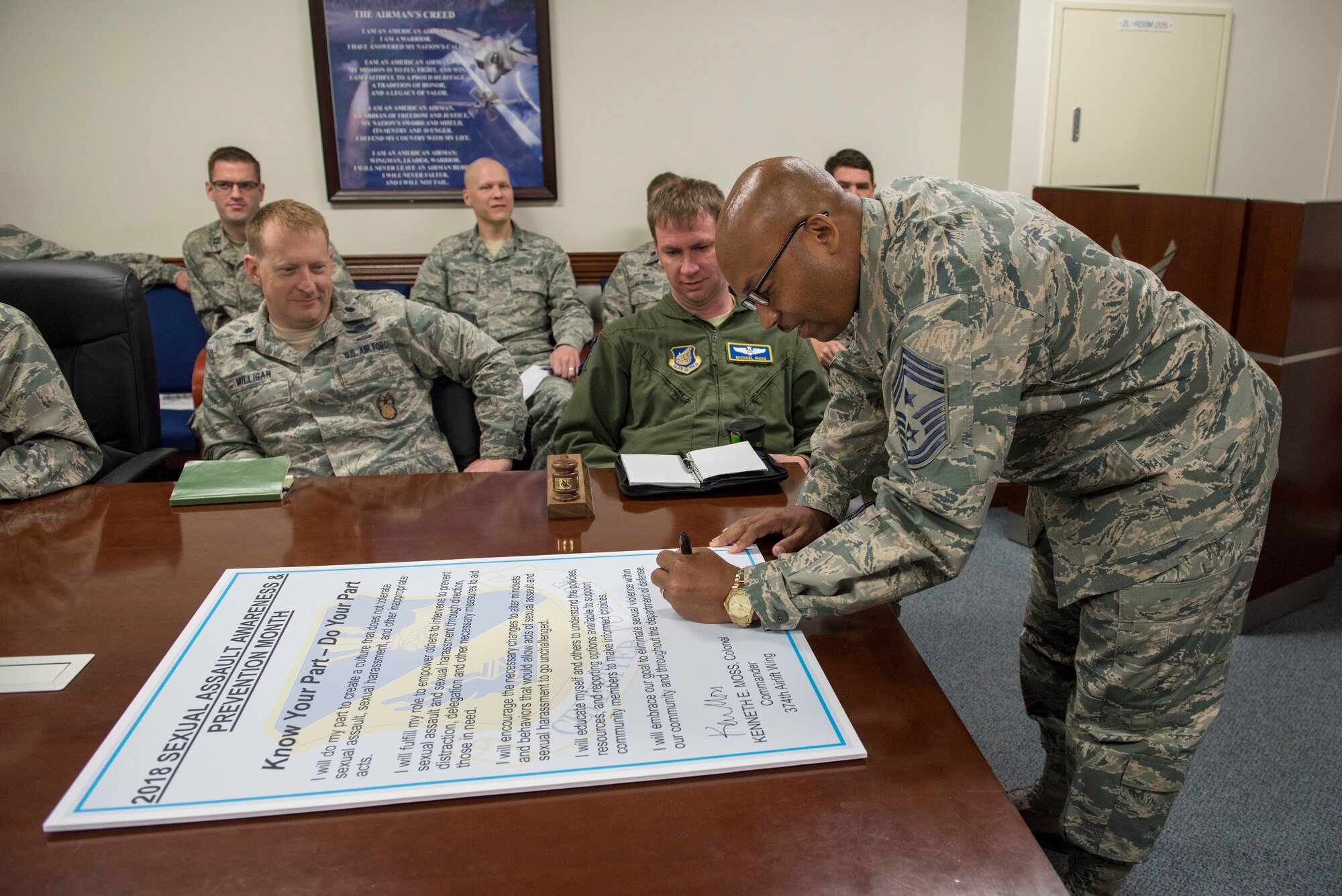 Chief Master Sgt. Elvin L. Young, 374th Airlift Wing command chief, signs the Sexual Assault Awareness & Prevention Month proclamation at Yokota Air Base, Japan, April 3, 2018.