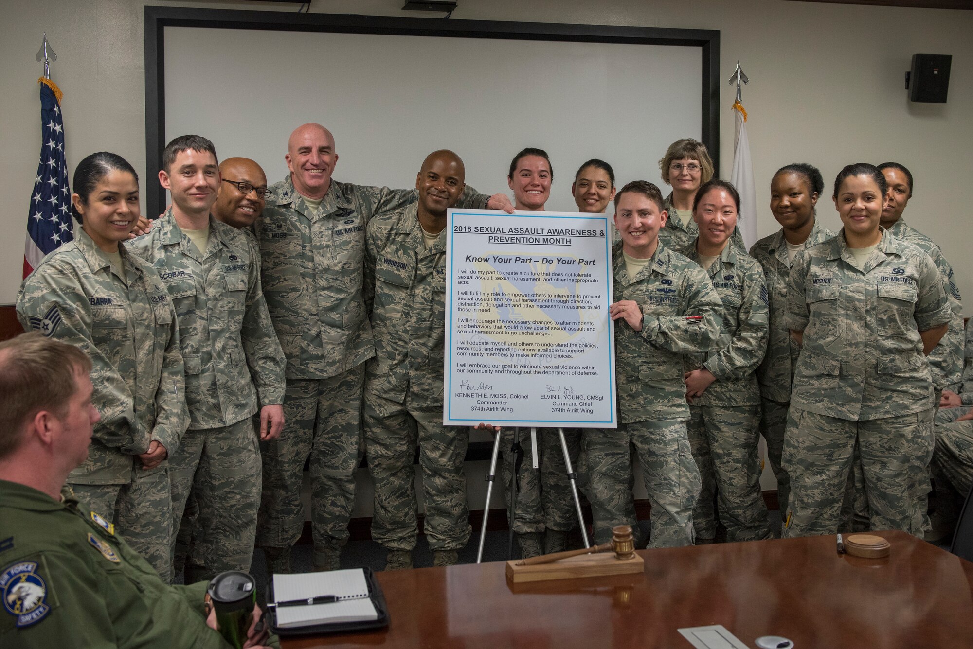 Col. Kenneth E. Moss, 374th Airlift Wing commander, and Chief Master Sgt. Elvin L. Young, 374 AW command chief, pose for a photo with the Victim Advocates of Team Yokota at Yokota Air Base, Japan, April 3, 2018.