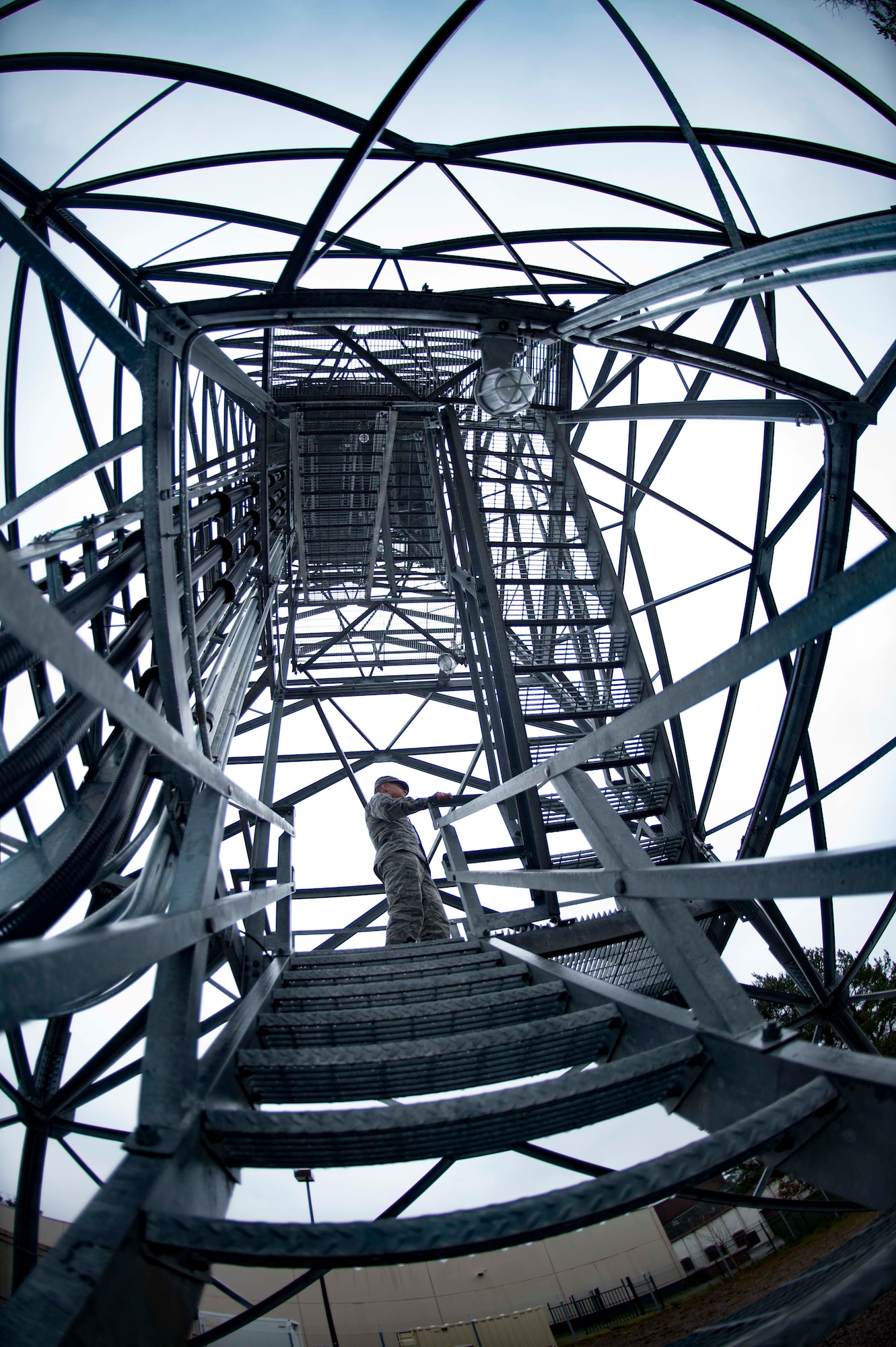 U.S. Air Force Airman 1st Class Connor Murph, 86th Operations Support Squadron Air Traffic Control and Landing Systems radar, airfield, and weather systems technician, climbs the Digital Airport Surveillance Radar tower on Ramstein Air Base, Germany, Mar. 22, 2018. Maintaining air traffic control and landing systems takes attention to detail, a huge database of knowledge, and the ability to withstand heights. (U.S. Air Force photo by Senior Airman Elizabeth Baker)