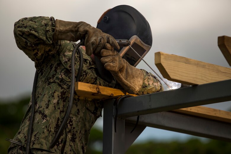 Seabees help marines for the Medal of Honor Hospital Corpsman 3rd Class Bush Battle Aid Station for the Correctional Custody Unit 2.0 program March 28 aboard Camp Hansen, Okinawa, Japan.