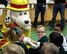 Sparky the Fire Dog, 100th Civil Engineer Squadron Fire Department mascot, greets young students from the Great Heath Academy in Mildenhall, England, March 27, 2018. The firefighters showed the children what their gear is used for, explained how it protects them, and allowed the children to try on the gear. (U.S. Air Force photo by Airman 1st Class Alexandria Lee)