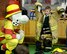 A young student from the Great Heath Academy tries on firefighter gear from RAF Mildenhall, March 27, 2018. The firefighters showed the children what their gear is used for, explained how it protects them and allowed the children to try on the gear. (U.S. Air Force photo by Airman 1st Class Alexandria Lee)