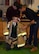 U. S. Air Force Airmen 1st Class Levi Brakenwagon and Isaiah Gwaltney, both 100th Civil Engineer Squadron firefighters, help a primary school student as he tries on a set of bunkers during a school visit at Great Heath Academy in Mildenhall, England, March 27, 2018. The firefighters participate in several volunteer events throughout the year at schools in the local community, focusing on educating children on fire safety. (U.S. Air Force photo by Airman 1st Class Alexandria Lee)