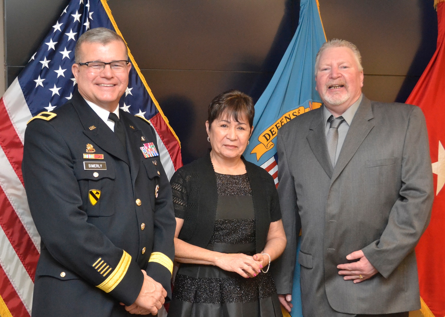 Photo. Dewey Smith, an equal employment specialist, and Nereida Rivera, a hand embroidery fabric worker, were honored during a retirement ceremony March 29. The retirees have 43 years of combined federal service.