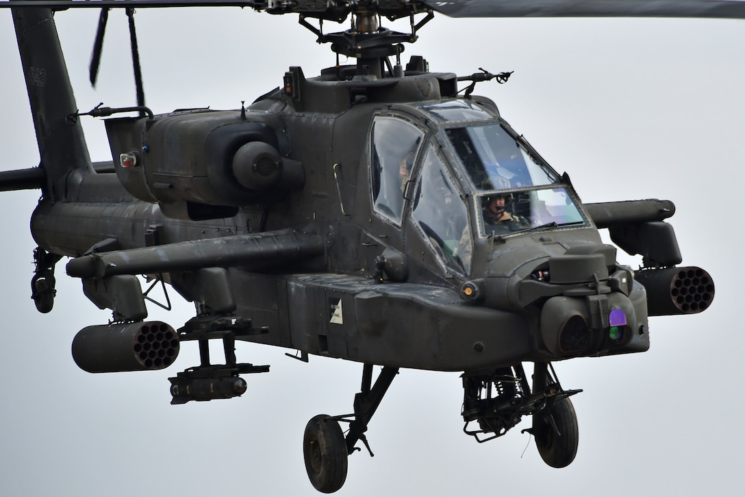 An AH-64D Apache Longbow helicopter provides aerial support.