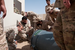 Kuwait Land Force explosive ordnance disposal-qualified officers discuss tactics and techniques for defeating improvised explosive devices during joint training with U.S. EOD technicians at Udari Range Complex near Camp Buehring, Kuwait, March 22, 2018. Army photo by Sgt. David L. Nye