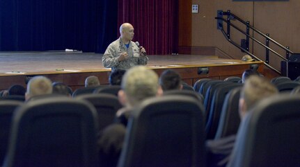 U.S. Air Force Col. Jimmy Canlas, 437th Airlift Wing commander, delivers opening remarks during the annual motorcycle rider’s safety briefing March 30, 2018, at the Air Base Theater.