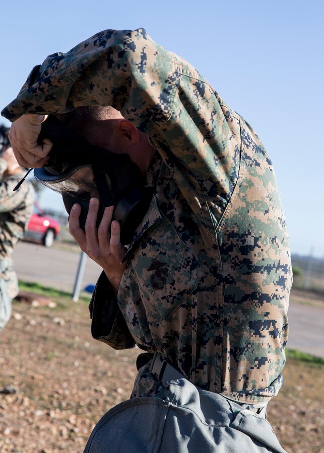 Cpl. Ashten Derickson, a cyber network operator with 3rd Marine Aircraft Wing, dons an M50 Joint Service General Purpose Mask during the reconnaissance, surveillance and decontamination course at Marine Corps Air Station Miramar, Calif., March 25. The course is designed to train unit personnel in the procedures and equipment used in accomplishing RS&D operations in a chemical, biological, radiological or nuclear environment. (U.S. Marine Corps photo by Lance Cpl. Clare J. McIntire)