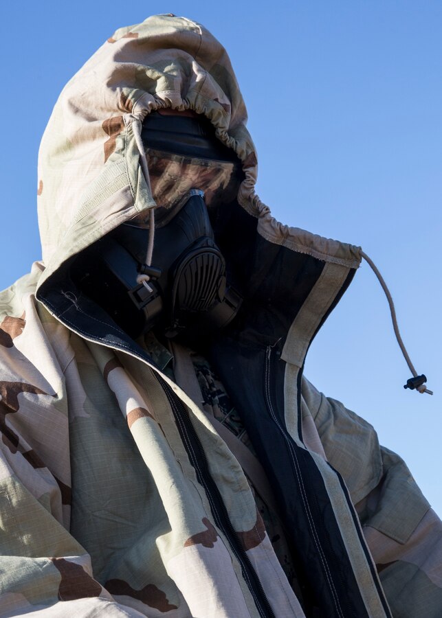 Cpl. Ashten Derickson, a cyber network operator with 3rd Marine Aircraft Wing, dons a Mission Oriented Protective Posture suit during the reconnaissance, surveillance and decontamination course at Marine Corps Air Station Miramar, Calif., March 25. The course is designed to train unit personnel in the procedures and equipment used in accomplishing RS&D operations in a chemical, biological, radiological or nuclear environment. (U.S. Marine Corps photo by Lance Cpl. Clare J. McIntire)