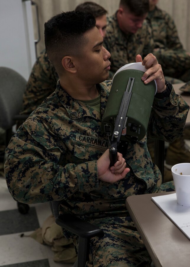 Cpl. Jovenian Carranza, an administrative specialist with 3rd Marine Aircraft Wing, inspects radiation equipment during the reconnaissance, surveillance and decontamination course at Marine Corps Air Station Miramar, Calif., March 25. The course is designed to train unit personnel in the procedures and equipment used in accomplishing RS&D operations in a chemical, biological, radiological or nuclear environment. (U.S. Marine Corps photo by Lance Cpl. Clare J. McIntire/released)