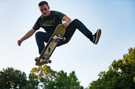 U.S. Air Force Airman 1st Class Nick Whitehurst, 633rd Communications Squadron client systems technician, nose-grabs his skateboard in Smithfield, Va., July 26, 2017.