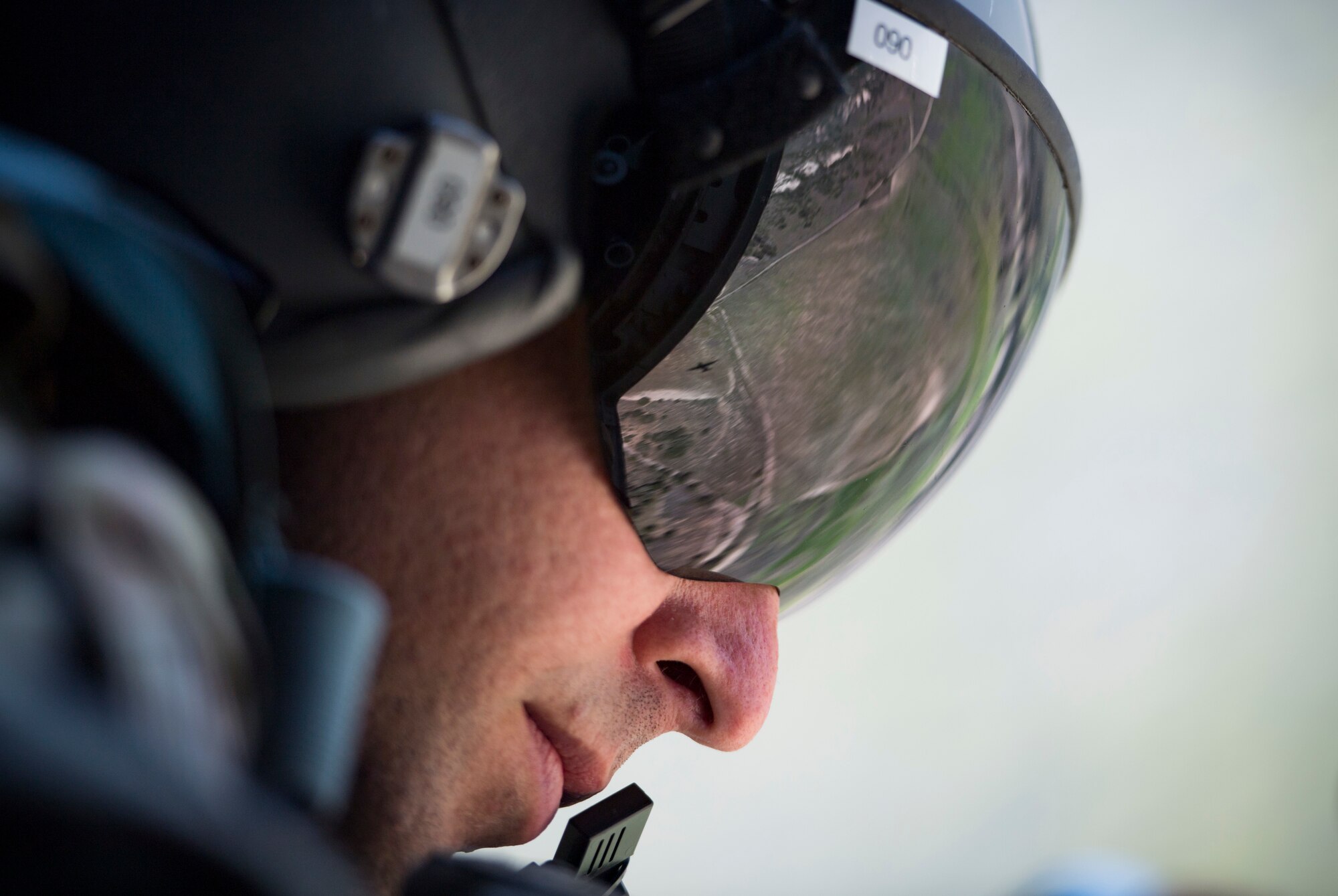 Tech. Sgt. Brandon Garbrick, 71st Rescue Squadron HC-130J Combat King II loadmaster, looks out of the door of an HC-130J during Tiger Rescue IV, March 27, 2018, at Vandenberg Air Force Base, Calif.  The four-day exercise challenged Airmen from multiple rescue squadrons to bring the capabilities of the personnel recovery triad together to successfully complete rescue missions and maintain proficiency. The three branches of the personnel recovery triad are the HC-130J, HH-60G Pave Hawk and the guardian angel weapons system or pararescuemen. (U.S. Air Force photo by Senior Airman Janiqua P. Robinson)