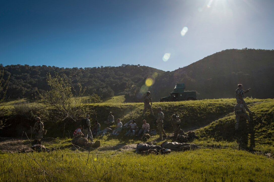 Pararescuemen from the 58th Rescue Squadron, Nellis Air Force Base, Nev.  provide care to simulated casualties during Tiger Rescue IV, March 28, 2018, at Vandenberg Air Force Base, Calif. The four-day exercise challenged Airmen from multiple rescue squadrons to bring the capabilities of the personnel recovery triad together to successfully complete rescue missions and maintain proficiency. The three branches of the personnel recovery triad are the HC-130J Combat King II, HH-60G Pave Hawk and the guardian angel weapons system or pararescuemen. (U.S. Air Force photo by Senior Airman Janiqua P. Robinson)