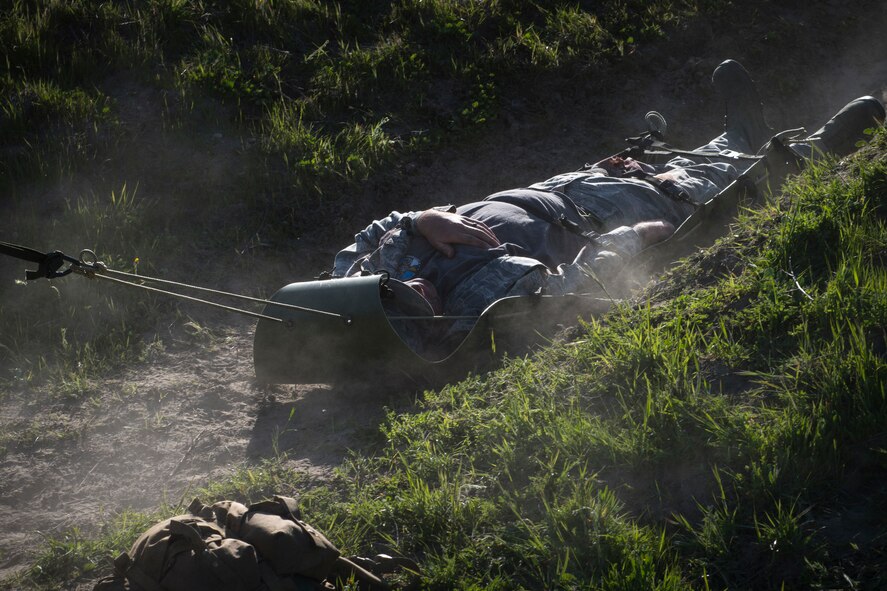 Pararescuemen from the 58th Rescue Squadron, Nellis Air Force Base, Nev., pull a simulated casualty to safety during Tiger Rescue IV, March 28, 2018, at Vandenberg Air Force Base, Calif. The four-day exercise challenged Airmen from multiple rescue squadrons to bring the capabilities of the personnel recovery triad together to successfully complete rescue missions and maintain proficiency. The three branches of the personnel recovery triad are the HC-130J Combat King II, HH-60G Pave Hawk and the guardian angel weapons system or pararescuemen. (U.S. Air Force photo by Senior Airman Janiqua P. Robinson)