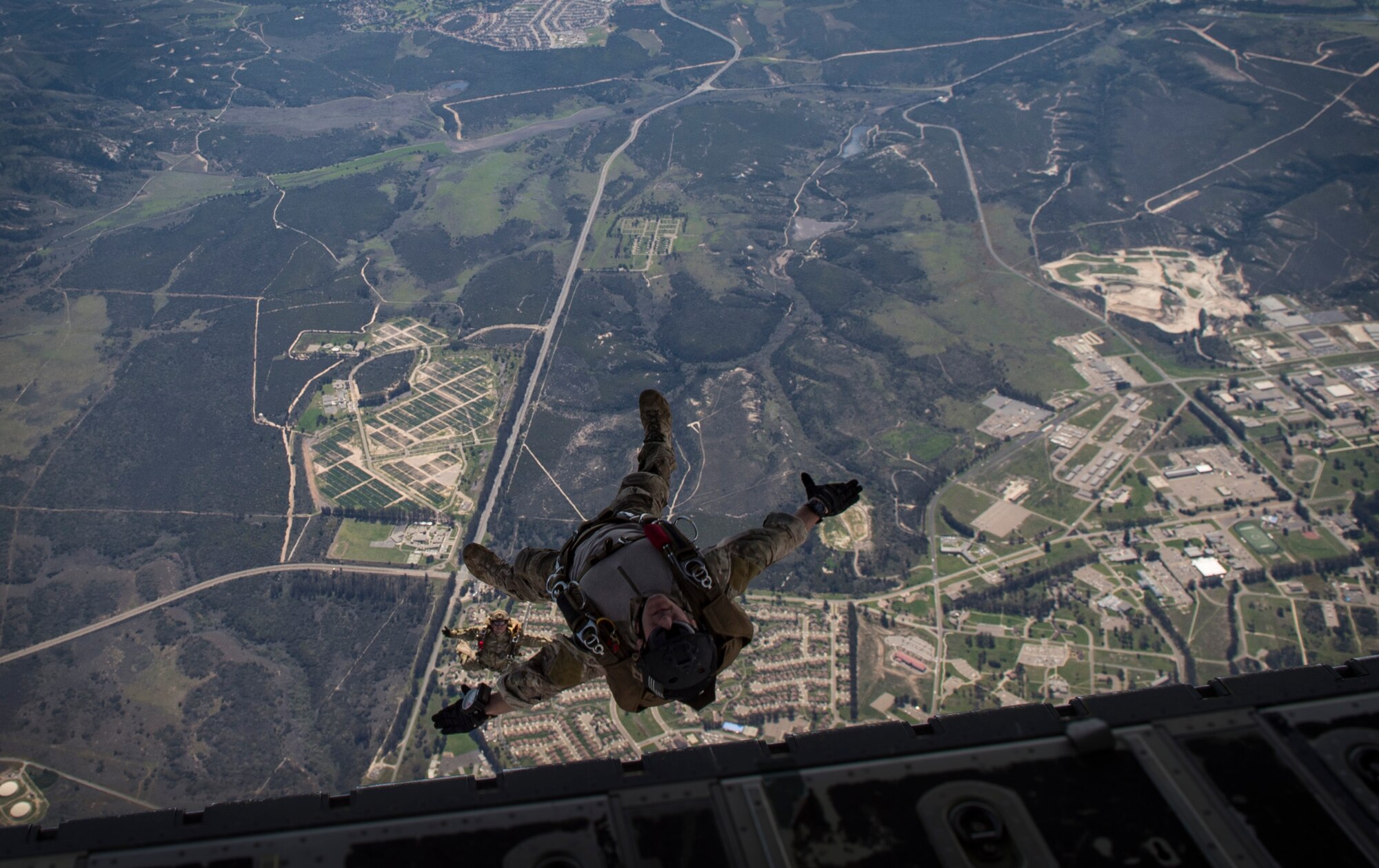 Pararescuemen from the 58th Rescue Squadron, Nellis Air Force Base, Nev., descend onto a drop zone during Tiger Rescue IV, March 30, 2018, at Vandenberg Air Force Base, Calif. The four-day exercise challenged Airmen from multiple rescue squadrons to bring the capabilities of the personnel recovery triad together to successfully complete rescue missions and maintain proficiency. The three branches of the personnel recovery triad are the HC-130J Combat King II, HH-60G Pave Hawk and the guardian angel weapons system or pararescuemen. (U.S. Air Force photo by Senior Airman Janiqua P. Robinson)