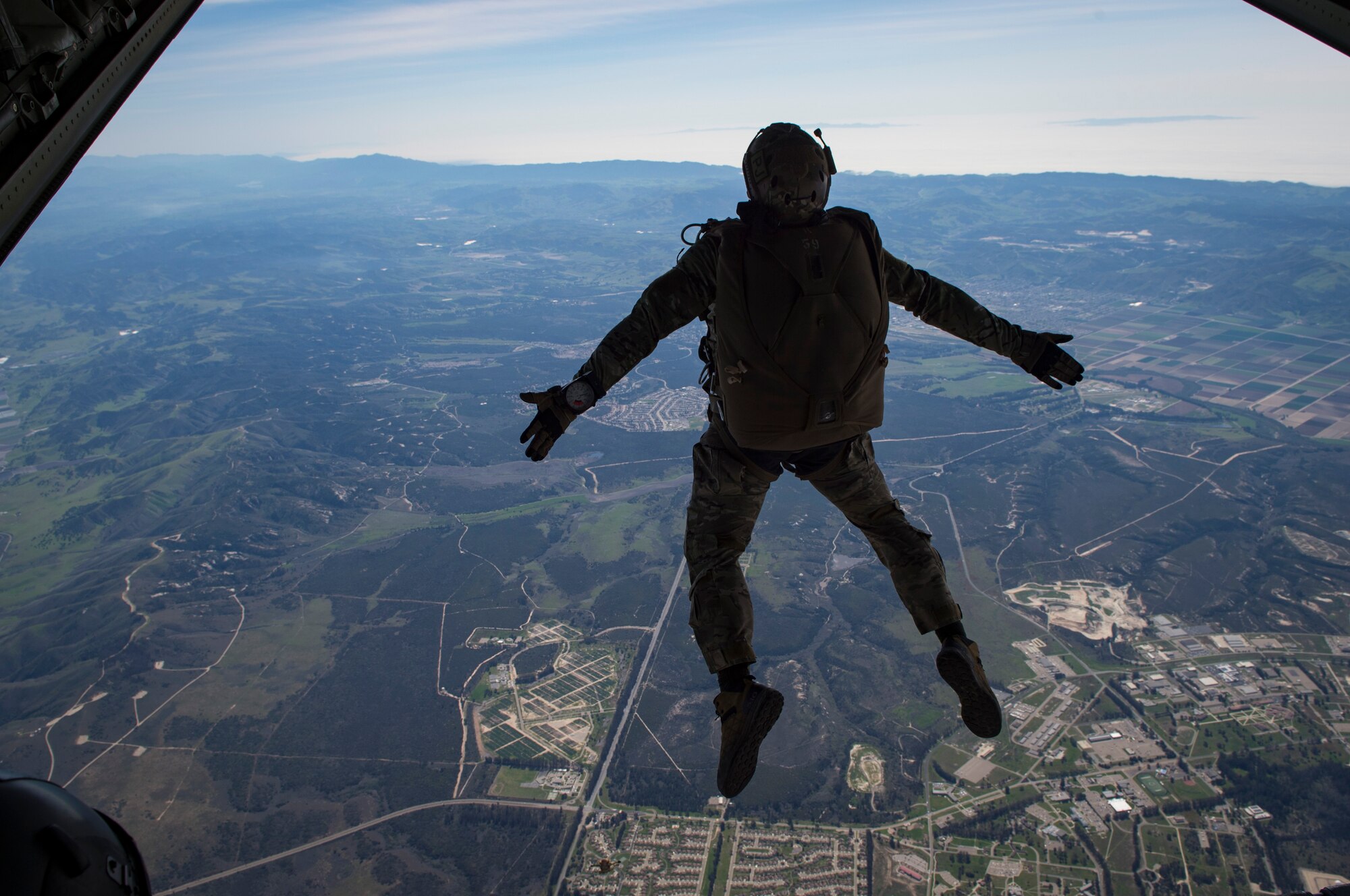A pararescueman from the 58th Rescue Squadron, Nellis Air Force Base, Nev., descends onto a drop zone during Tiger Rescue IV, March 30, 2018, at Vandenberg Air Force Base, Calif. The four-day exercise challenged Airmen from multiple rescue squadrons to bring the capabilities of the personnel recovery triad together to successfully complete rescue missions and maintain proficiency. The three branches of the personnel recovery triad are the HC-130J Combat King II, HH-60G Pave Hawk and the guardian angel weapons system or pararescuemen. (U.S. Air Force photo by Senior Airman Janiqua P. Robinson)