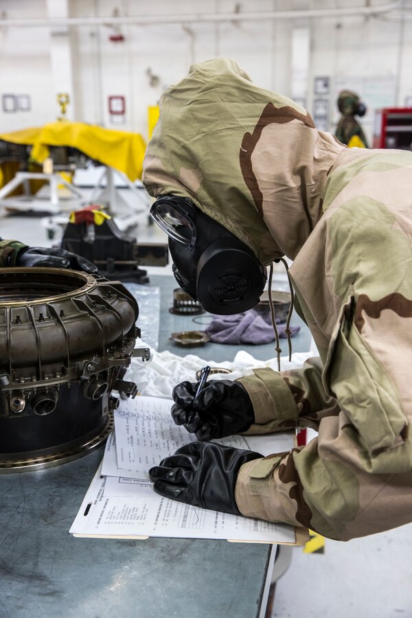 A Marine with Marine Aviation Logistics Squadron (MALS) 39 records serial numbers for inventory purposes at Marine Corps Air Station Camp Pendleton, Calif., March 20. MALS-39 tested their ability to support the flight line in a simulated chemical, biological, radiological and nuclear event. (U.S. Marine Corps photo by Lance Cpl. Nadia J. Stark/Released)