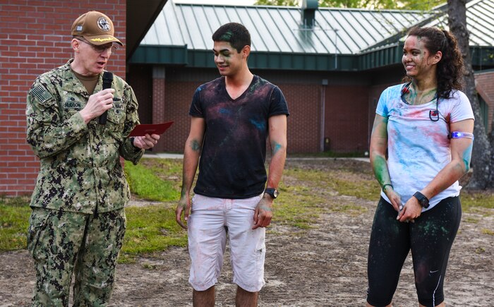 Capt. Robert Hudson, 628th Air Base Wing deputy commander, congratulates the fastest male and female runners after the Sexual Assault Awareness Prevention and Response color run at Joint Base Charleston, S.C., March 30, 2018.