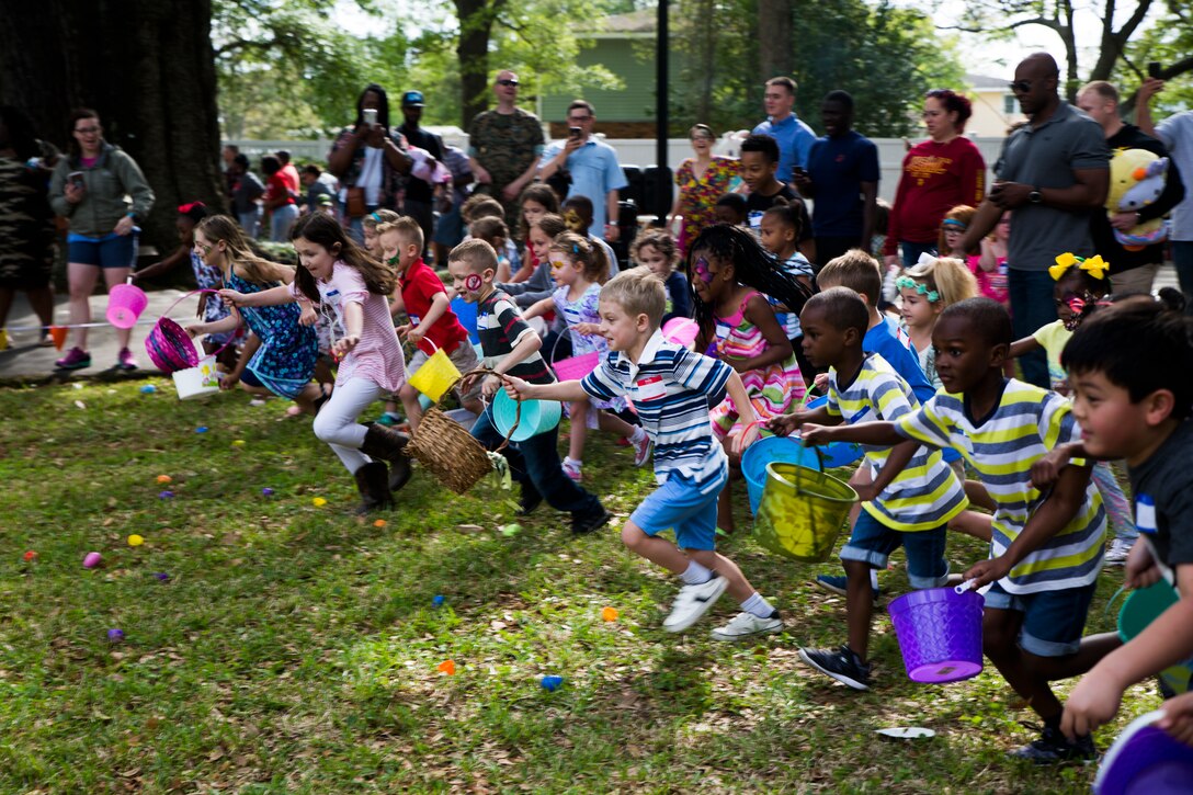 Children from the local community hit the ground running as the Marine Forces Reserve command sponsored Easter Egg Hunt kicks off at the historic home of Lt. Gen. Rex C. McMillian, commander of MARFORRES and Marine Force North, New Orleans, March 24, 2018. Families from the community were invited to attend the event, interact with the service members and celebrate the holiday together. (U.S. Marine Corps photo by Sgt. Melissa Martens)