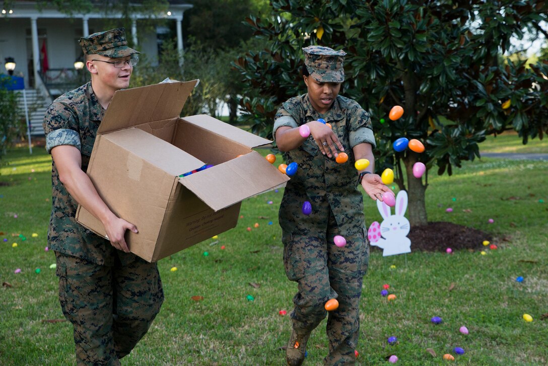 Marines from Marine Corps Support Facility New Orleans disperse eggs before the start of Marine Forces Reserve command sponsored Easter Egg Hunt at the historical home of Lt. Gen. Rex C. McMillian, commander of MARFORRES and Marine Force North, New Orleans, March 24, 2018. Families from the local community were invited to attend the event, interact with the service members and celebrate the holiday together. (U.S. Marine Corps photo by Sgt. Melissa Martens)