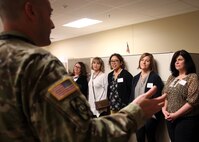 Army Capt. Joshua Krevy, secretary to the joint staff, JTF-CS, gives a tour of Mullan Hall to military member spouses March 21, 2018. The Key Spouse Program is a commander's program that is primarily used in the Air Force. According to the US Air Force Services website, it's an official unit/family program designed to enhance readiness and establish a sense of community. "Our primary focus is support for readiness and deployment," Mrs. Gallant, wife of Maj. Gen. Richard Gallant, commander, JTF-CS. said to a group of spouses. After a tour of the headquarters, the spouses sat down to discuss the current group and where it is headed. A new command team is coming in July. Along with that big change, several key leaders are moving on to their next duty stations. That means more volunteers are needed to continue a program that the Gallant family agrees is critical to the command.