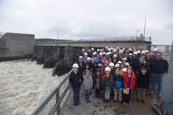 U.S. Army Corps of Engineers Nashville District employees pose with their children at Old Hickory Dam during a tour March 30, 2018 during "Bring Your Kids to Work Day." A total of 36 kids joined their parents for a tour of the dam, lock and power plant. (USACE Photo by Lee Roberts)