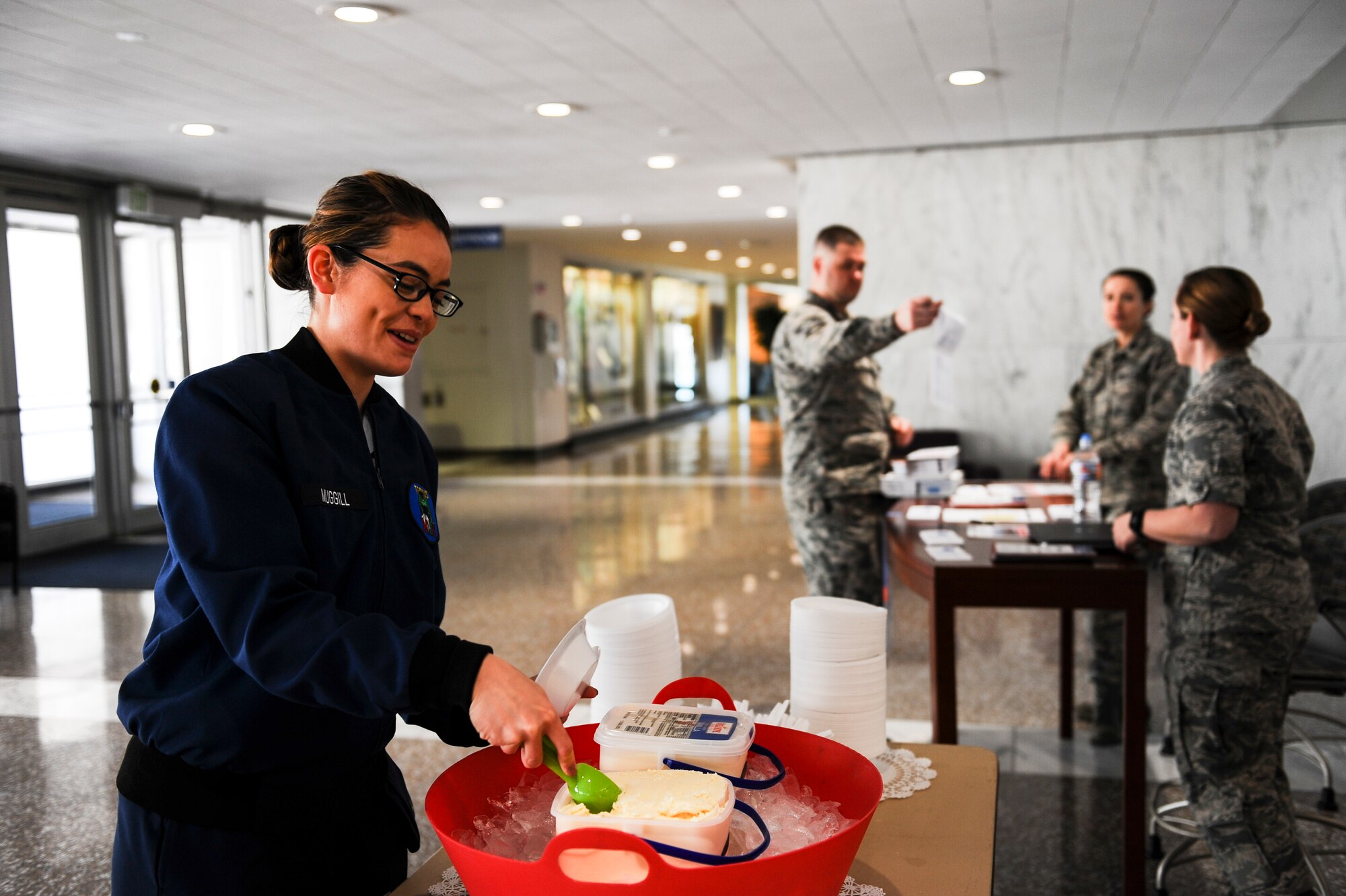 Cadet 3rd Class Gail Muggill, Cadet Squadron 20, participate in the Air Force Assistance Fund campaign’s ice cream social April 3, 2018, at Air Force Academy, Colorado. The Academy’s goal for 2018 is to raise approximately $45,000, which will benefit the Air Force Aid Society, Air Force Enlisted Village, Air Force Villages Charitable Foundation and the General and Mrs. Curtis E. LeMay Foundation. (U.S. Air Force photo/Tech. Sgt. Julius Delos Reyes)
