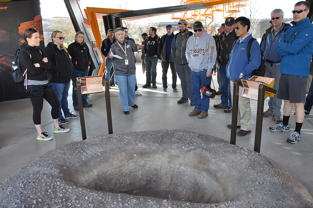 Margie Klein, interpretive naturalist with the Red Rock Canyon Visitor’s Center, shows U.S. Army Corps of Engineers geologists and technicians a roasting pit, one of many archeological features left behind by civilizations that once called the Red Rock Canyons home, during a March 15 tour of Red Rock Canyon National Conservation Area near Las Vegas.