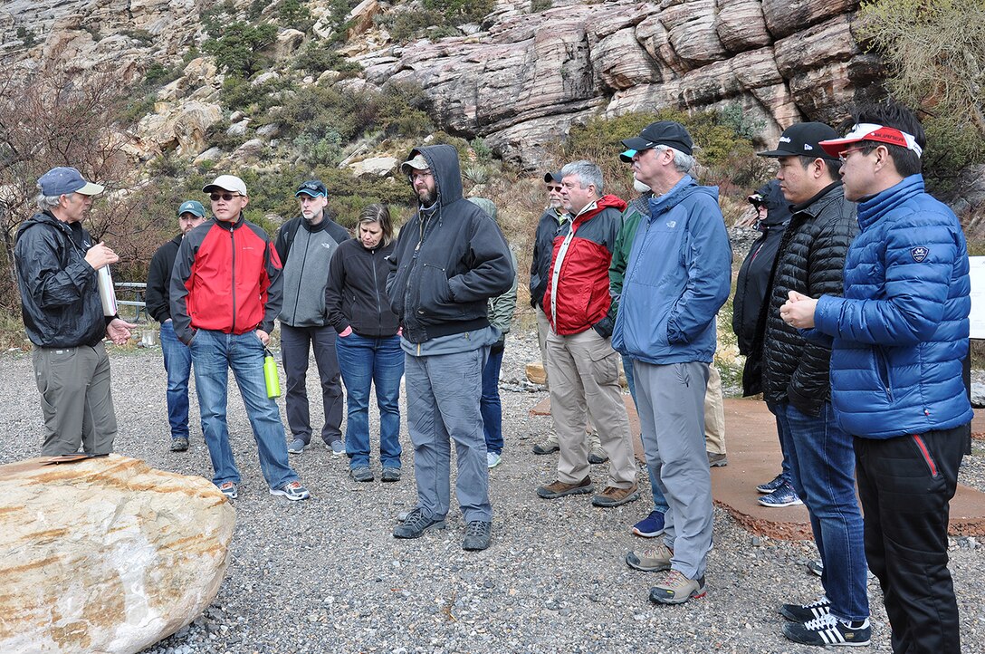 Keith Kelson, engineering geologist with the U.S. Army Corps of Engineers Sacramento District, left, discusses how clues from pre-historic and historic floods can help predict future flooding events with other U.S. Army Corps of Engineers geologists during an exercise March 15 at the Red Rock Canyon National Conservation Area near Las Vegas.