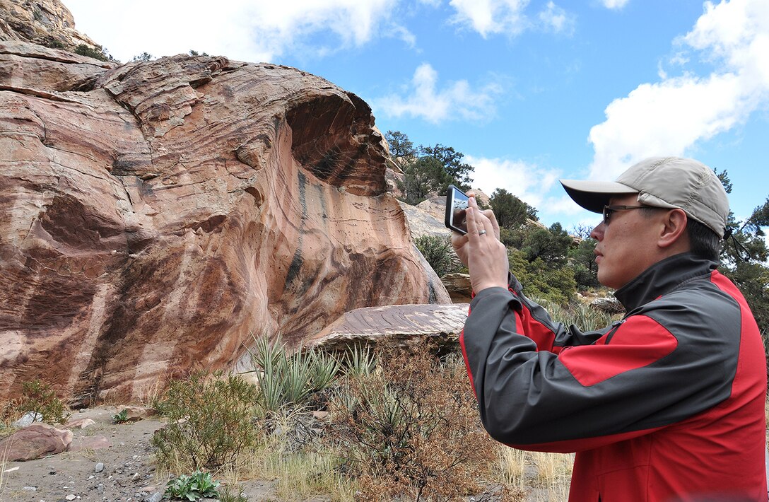 A U.S. Army Corps of Engineers geologist takes a picture of clay imprints on a canyon wall – a predictor indicating that previous pre-historic flood levels had not risen to that height in hundreds, or perhaps, thousands of years – during a paleoflood exercise March 15 at the Red Rock Canyon National Conservation Area near Las Vegas.
