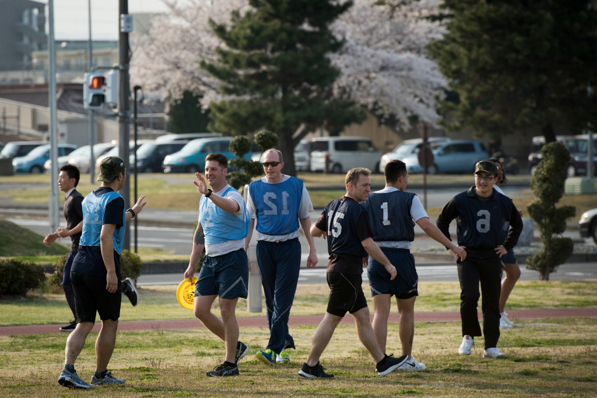 Teammates congratulate each other after scoring a point during an ultimate frisbee match, March 28, 2018, Yokota Air Base, Japan.