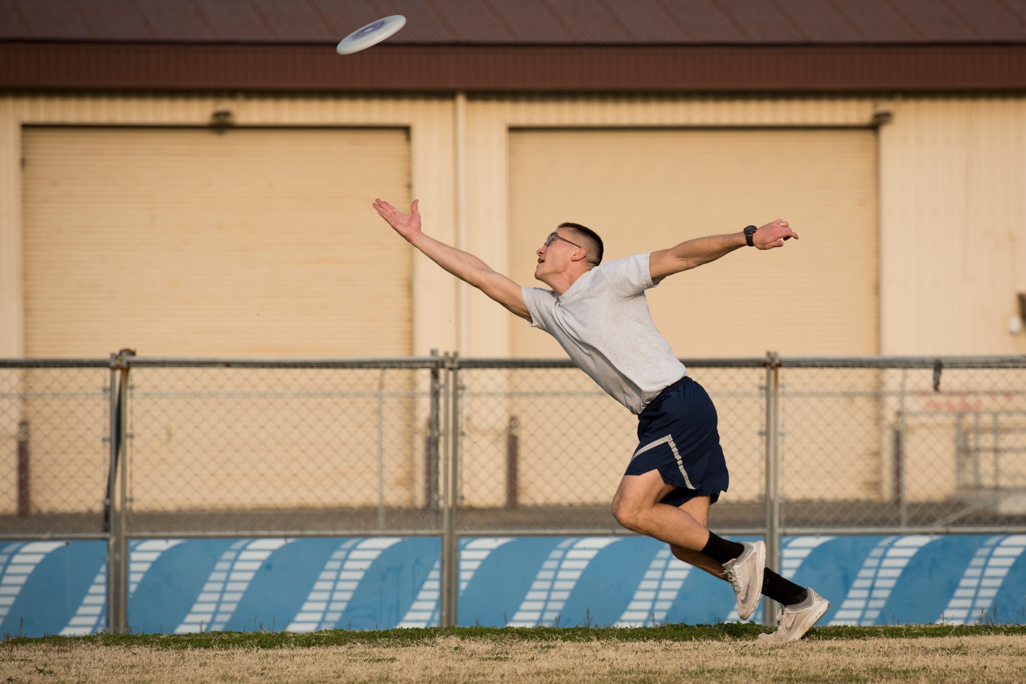 A player dives for the disk in the end zone during an ultimate frisbee match, March 28, 2018, Yokota Air Base, Japan.
