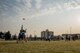 Players reach for a disk during an ultimate frisbee match, March 28, 2018, Yokota Air Base, Japan.
