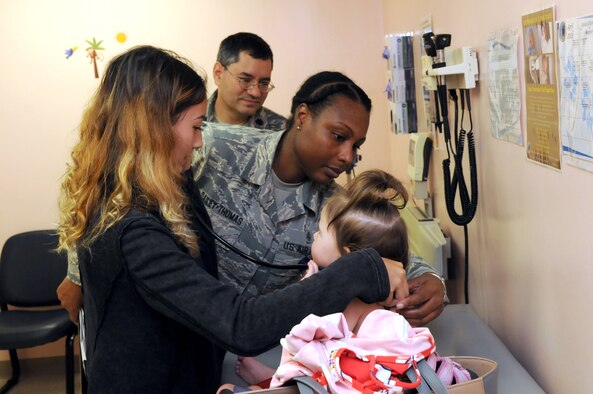 McKayla Richardson, a student from Radford High School, assists Staff Sgt. Adele J. Dailey-Thomas and Lt. Col. Aaron S. Thaker from the 15th Medical Operations Squadron pediatrics clinic during Career Shadow Day at the 15th Medical Group, Joint Base Pearl Harbor-Hickam, Hawaii, March 28, 2018.