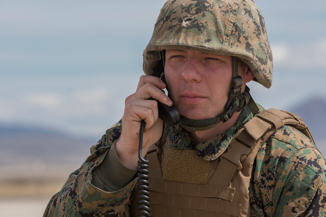 Marine Corps Sgt. Joshua Herod, communications chief with Kilo Battery, 2nd Battalion, 14th Marine Regiment, radios target coordinates to an M142 High Mobility Artillery Rocket System (HIMARS) at Dugway Proving Grounds, Utah, March 30, 2018. Marines from Kilo Battery flew from Fort Campbell, Ky., to Dugway where they offloaded and fired four HIMARS missiles, demonstrating a unique capability that will give commanders more options to deal with threats when other options are not appropriate. (Marine Corps photo by Lance Cpl. Niles Lee)