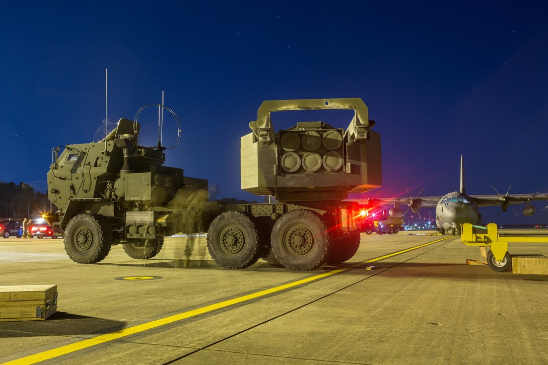 Marines from Kilo Battery, 2nd Battalion, 14th Marine Regiment, inspect a M142 High Mobility Artillery Rocket System (HIMARS) after being offloaded from an Air Force MC-130, on Fort Campbell, Ky., March 30, 2018. Marines from Kilo Battery flew from Fort Campbell to Dugway Proving Grounds, Utah, where they offloaded and fired four HIMARS missiles, demonstrating a unique capability that will give commanders more options to deal with threats when other options are not appropriate. (Marine Corps photo by Lance Cpl. Niles Lee)