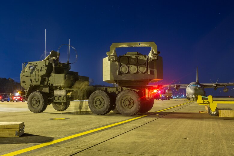 Marines from Kilo Battery, 2nd Battalion, 14th Marine Regiment, inspect a M142 High Mobility Artillery Rocket System (HIMARS) after being offloaded from an Air Force MC-130, on Fort Campbell, Ky., March 30, 2018. Marines from Kilo Battery flew from Fort Campbell to Dugway Proving Grounds, Utah, where they offloaded and fired four HIMARS missiles, demonstrating a unique capability that will give commanders more options to deal with threats when other options are not appropriate. (Marine Corps photo by Lance Cpl. Niles Lee)