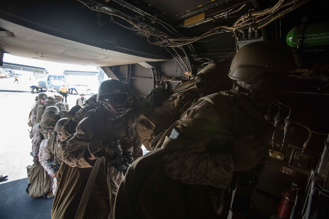 180402-M-WP334-0012 U.S. 5TH FLEET AREA OF OPERATIONS (April 2, 2018) U.S. Marines assigned to the Maritime Raid Force (MRF), 26th Marine Expeditionary Unit (MEU), board an MV-22B Osprey, assigned to Marine Medium Tiltrotor Squadron (VMM) 162 (Reinforced), 26th MEU, on the flight deck of the Wasp-class amphibious assault ship USS Iwo Jima (LHD 7), April 2, 2018. Led by Naval Amphibious Force, Task Force 51/5th Marine Expeditionary Brigade, Alligator Dagger integrates U.S. Navy and Marine Corps assets to practice and rehearse a range of critical capabilities available to U.S. Central Command both afloat and ashore to promote stability and security in the region.