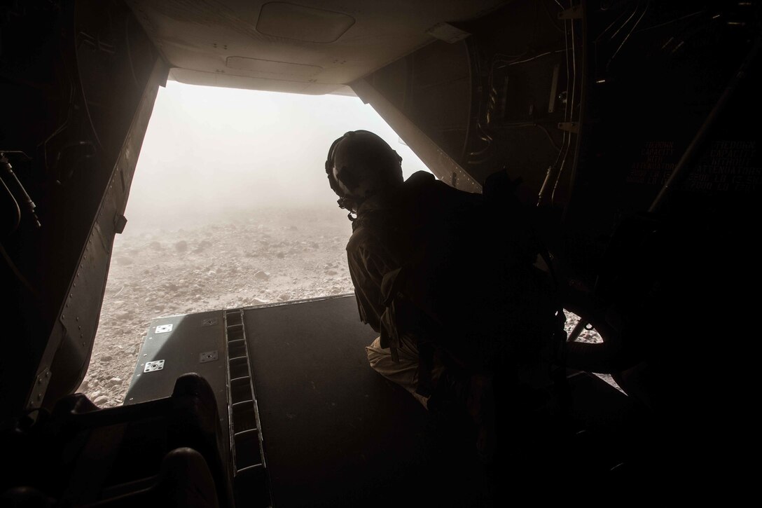 180402-M-WP334-0027 ARTA RANGE, Djibouti (April 2, 2018) U.S. Marine Corps Lance Cpl. Bailey Quinn, an MV-22B Osprey crew chief assigned to Marine Medium Tiltrotor Squadron (VMM) 162 (Reinforced), 26th Marine Expeditionary Unit, observes the surroundings from the inside of an MV-22B Osprey prior to landing during Alligator Dagger in Arta Range, Djibouti, April 2, 2018. Led by Naval Amphibious Force, Task Force 51/5th Marine Expeditionary Brigade, Alligator Dagger integrates U.S. Navy and Marine Corps assets to practice and rehearse a range of critical capabilities available to U.S. Central Command both afloat and ashore to promote stability and security in the region.