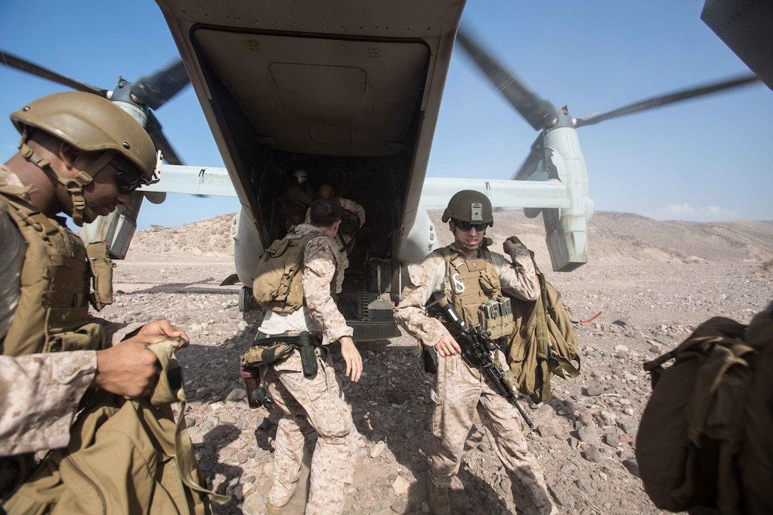 180402-M-WP334-0040 ARTA RANGE, Djibouti (April 2, 2018) U.S. Marines assigned to the Maritime Raid Force (MRF), 26th Marine Expeditionary Unit (MEU), offload gear from an MV-22B Osprey, assigned to Marine Medium Tiltrotor Squadron (VMM) 162 (Reinforced), 26th MEU, in Arta Range, Djibouti, April 2, 2018. Led by Naval Amphibious Force, Task Force 51/5th Marine Expeditionary Brigade, Alligator Dagger integrates U.S. Navy and Marine Corps assets to practice and rehearse a range of critical capabilities available to U.S. Central Command both afloat and ashore to promote stability and security in the region