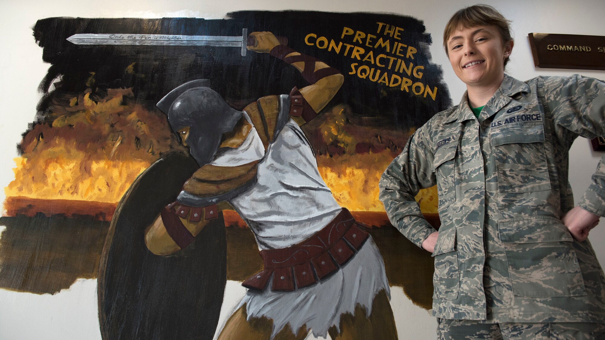 Service member poses for a photo for Wing award.