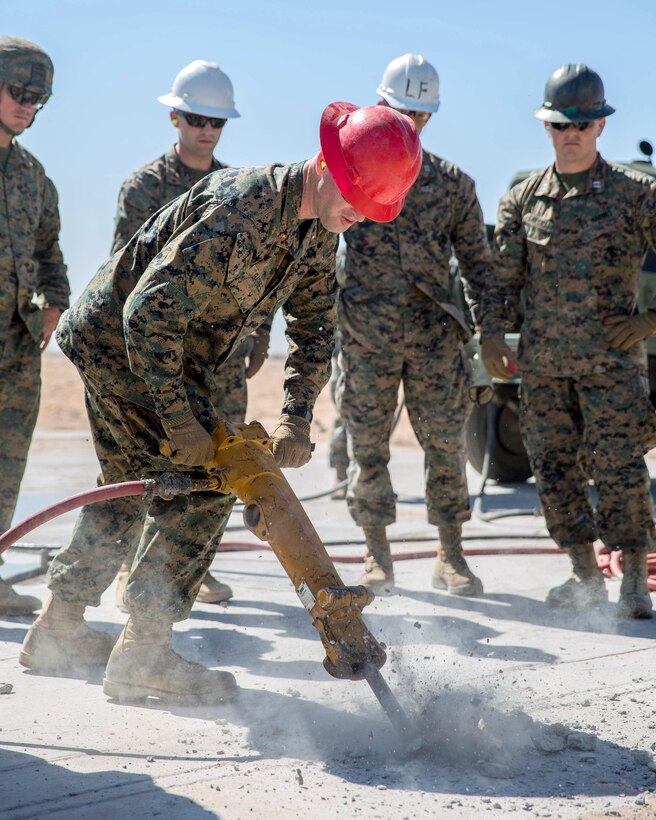 A Marine fixes a runway crack during airfield damage repair operations.