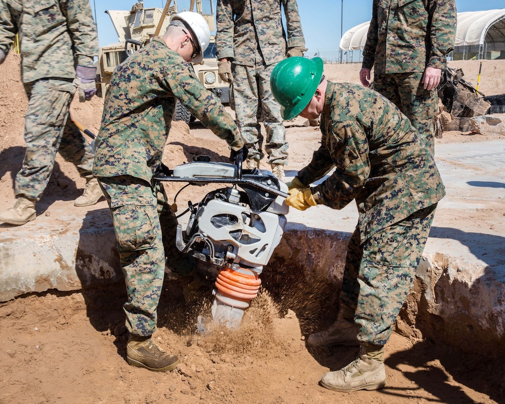 Marines operate a compactor during airfield damage repair operations.