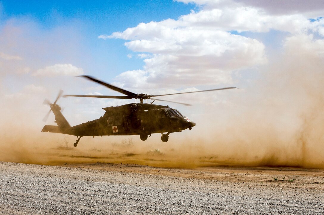 A UH-60 Black Hawk helicopter lands.
